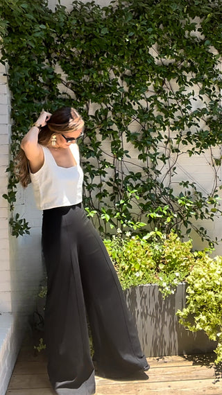 Girl wearing white linen top with wide leg black ponte knit high waisted pants